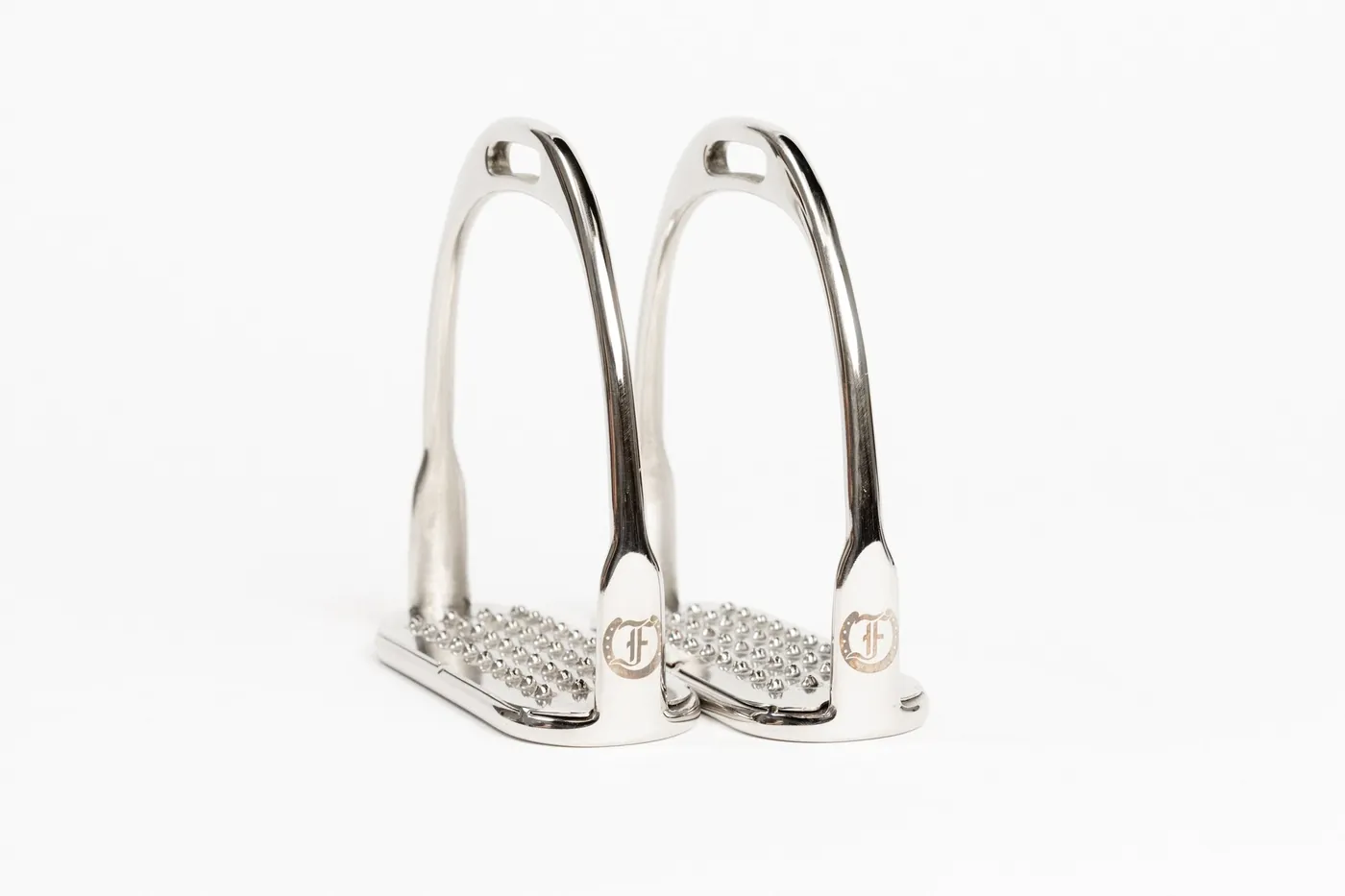 A pair of nickel stirrup irons stamped with the Freedman F, from the shop's current hardware line.